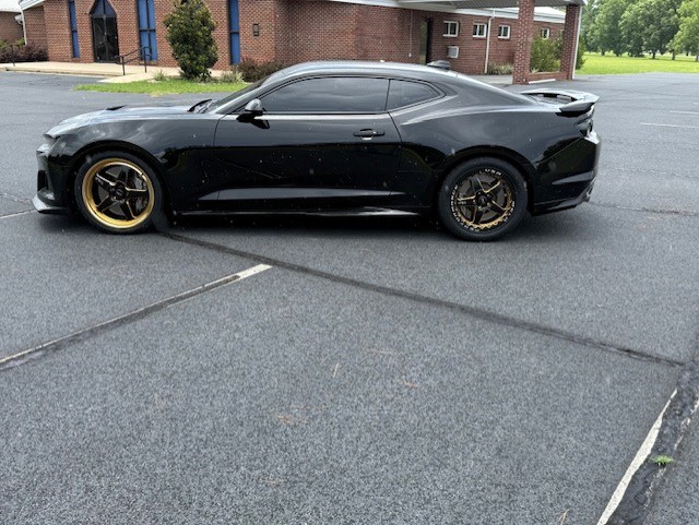 Finished black Chevrolet Camaro on bronze wheels