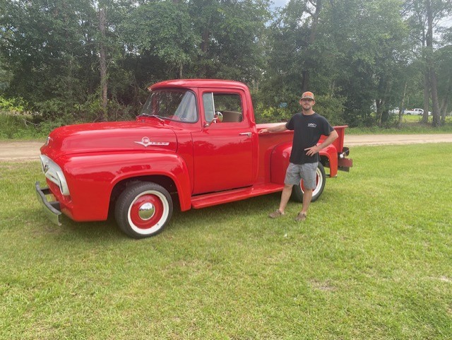 Finished red 1956 Ford F-100 pickup with whitewall tires