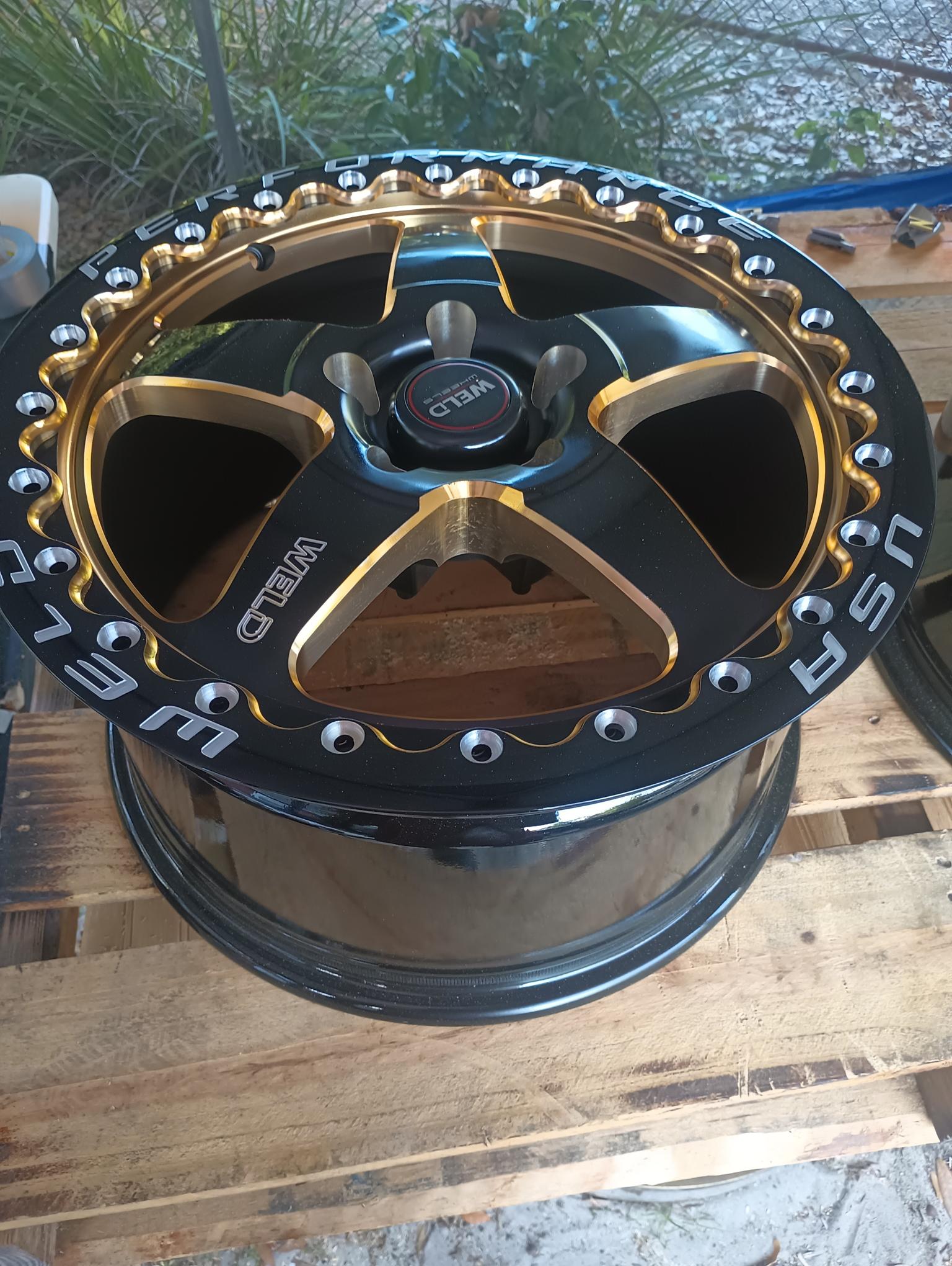 Custom black and gold beadlock wheel